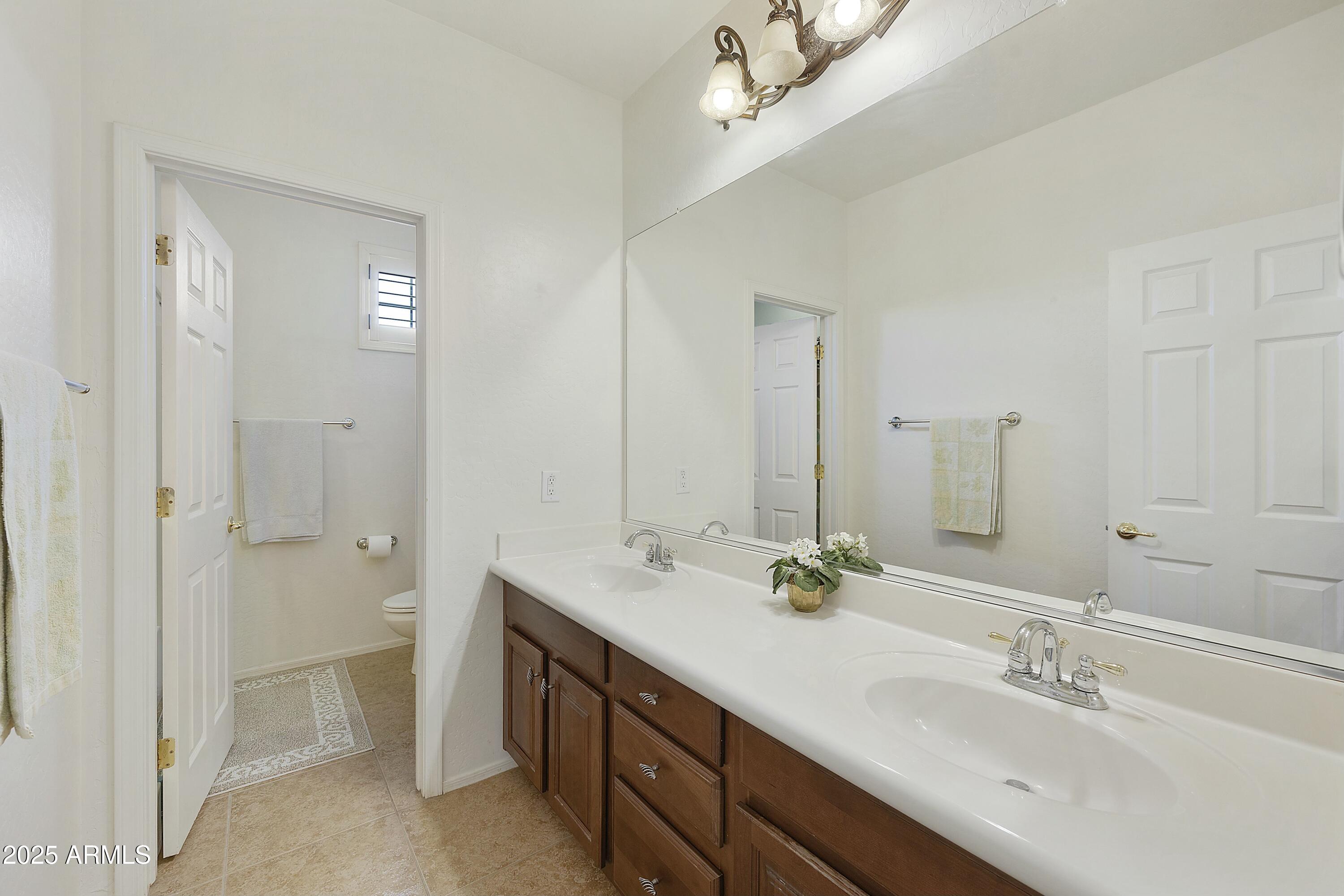 4615 West Corral Road Laveen, AZ 85339 - Photo 37 of 48 a spacious bathroom with a double vanity sink mirror and shower