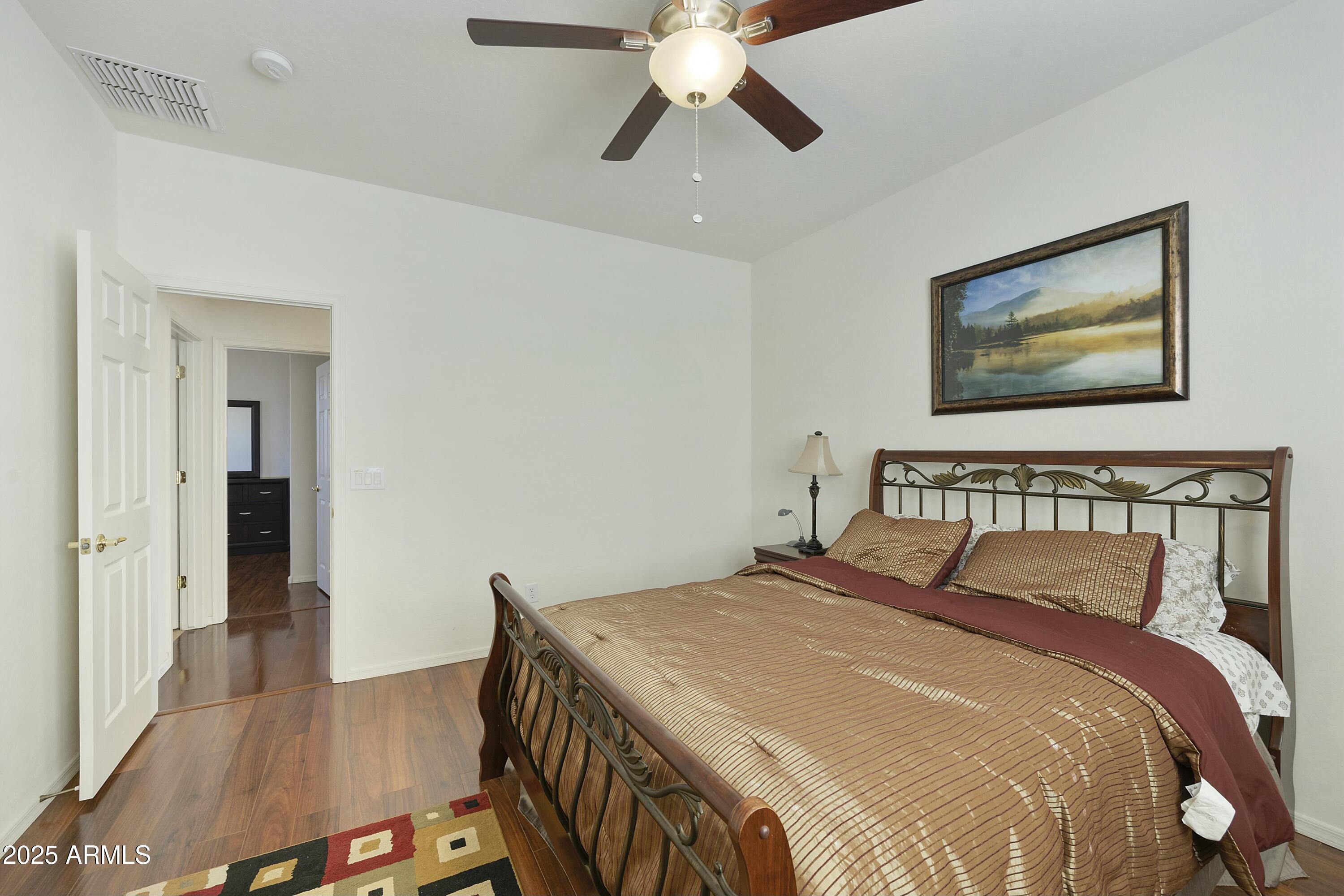 4615 West Corral Road Laveen, AZ 85339 - Photo 38 of 48 a bedroom with a bed and a chandelier