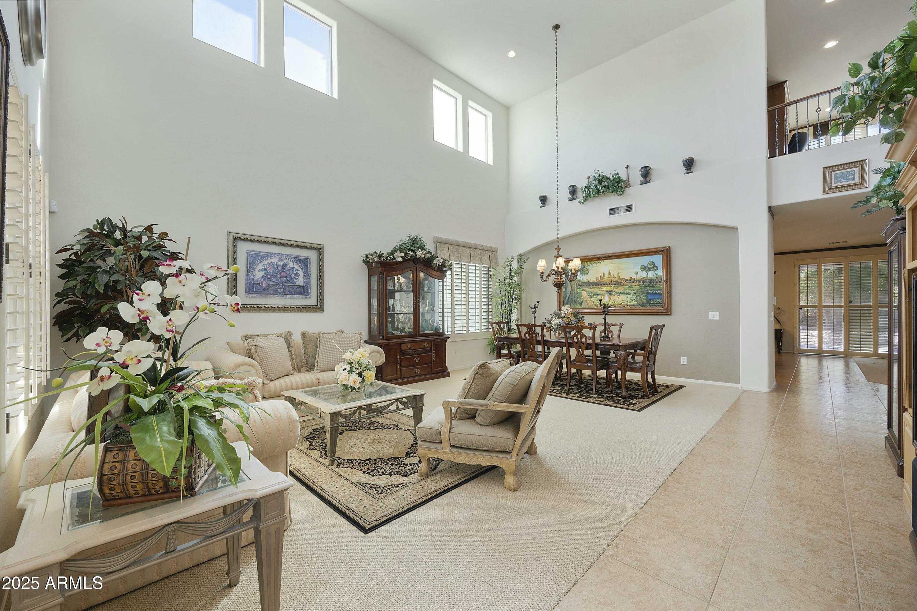 4615 West Corral Road Laveen, AZ 85339 - Photo 4 of 48 a living room with furniture a potted plant and a large window