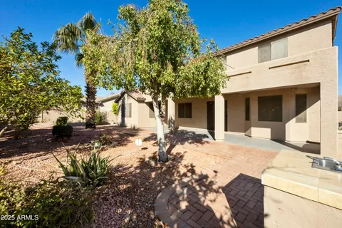 a view of a white house with a tree