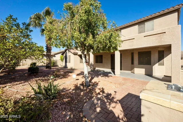 a view of a white house with a tree