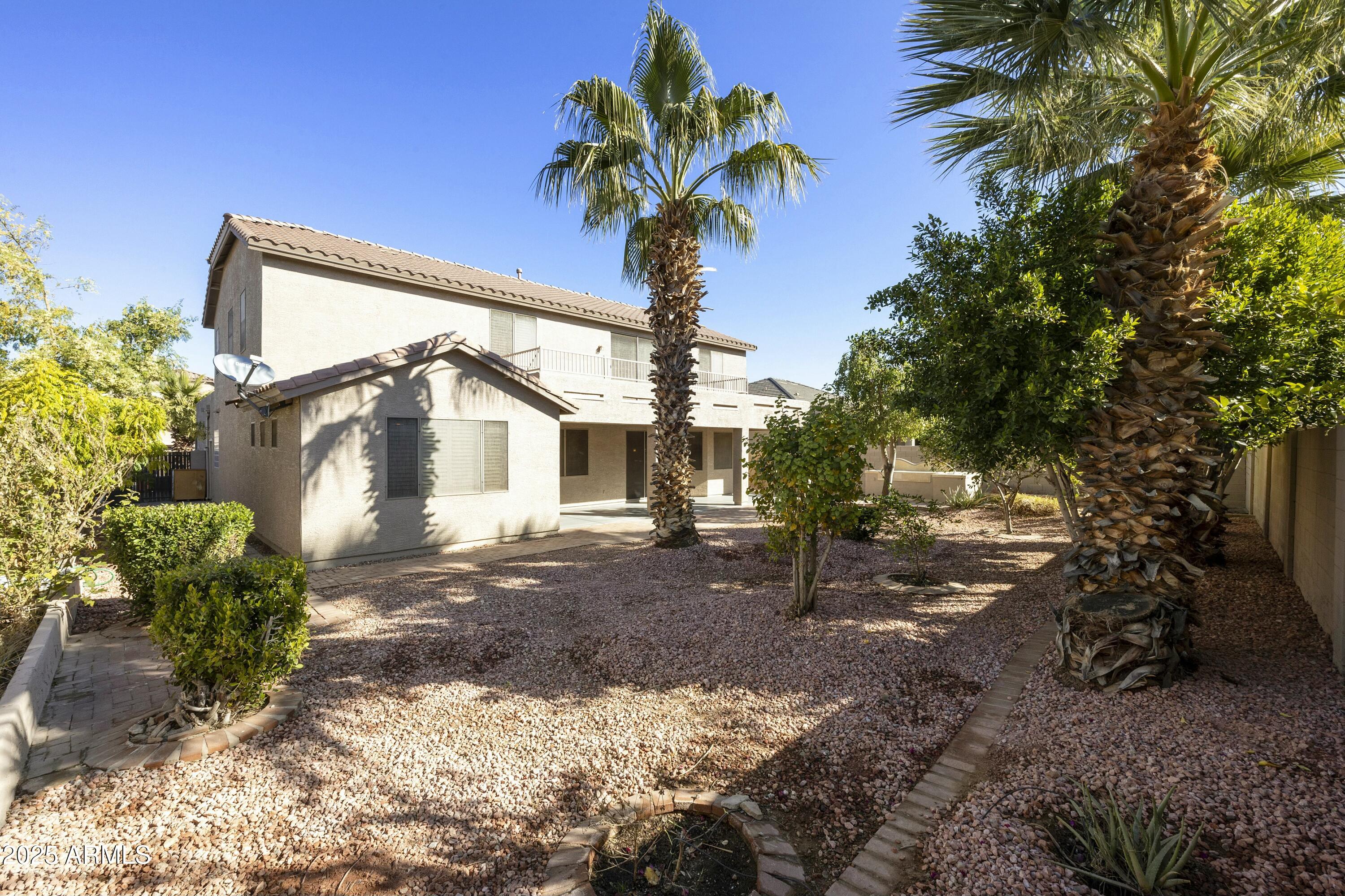4615 West Corral Road Laveen, AZ 85339 - Photo 46 of 48 a front view of a house with a yard and garage