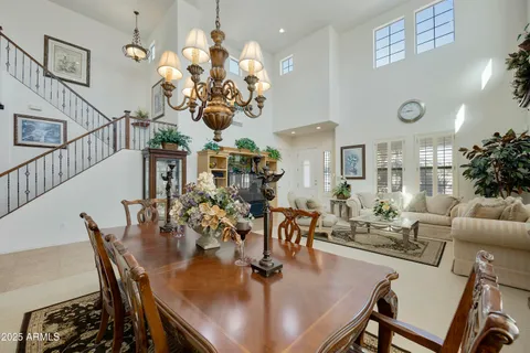 a view of a dining room with furniture and chandelier