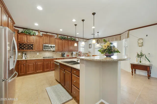 a kitchen with stainless steel appliances granite countertop a sink a stove and a refrigerator