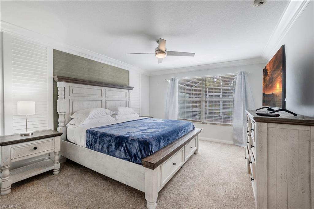 7221 Bellini Way Naples, FL 34114 - Photo 22 of 43 a bedroom with a bed and a flat screen tv