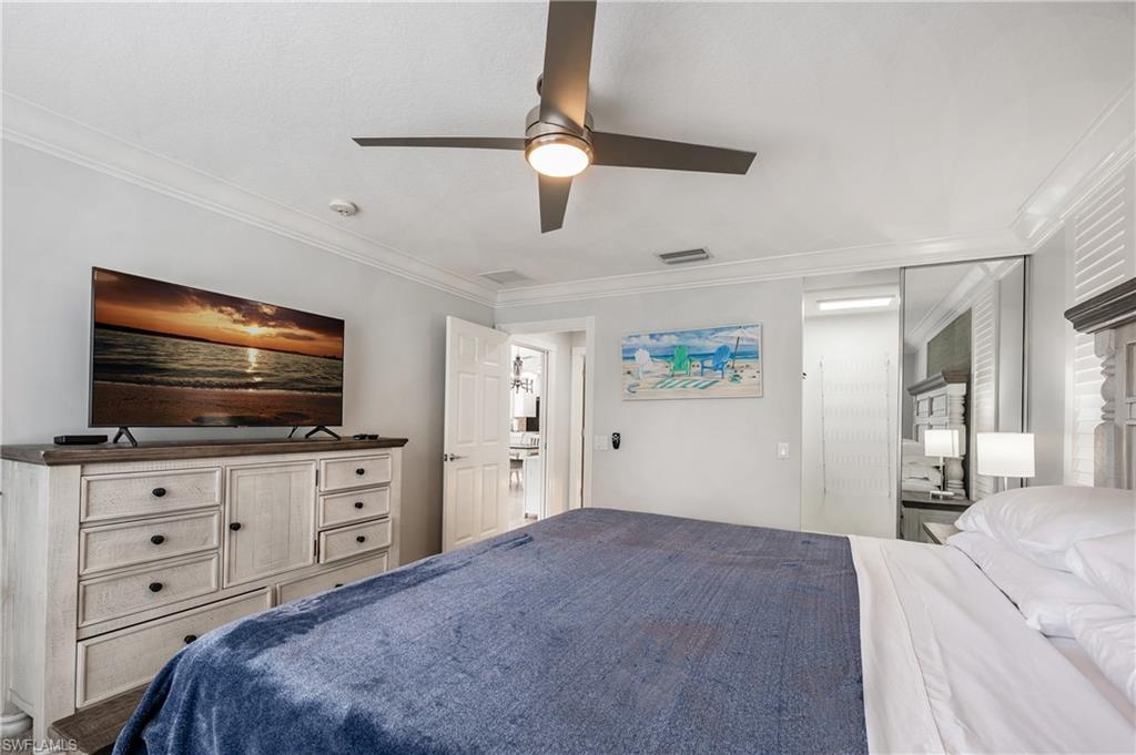 7221 Bellini Way Naples, FL 34114 - Photo 23 of 43 a bedroom with a bed and a flat screen tv