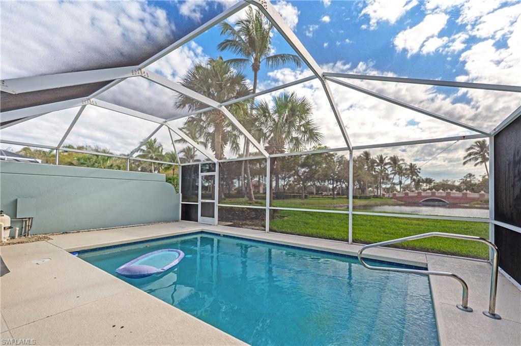 7221 Bellini Way Naples, FL 34114 - Photo 25 of 43 a view of a backyard with a swimming pool