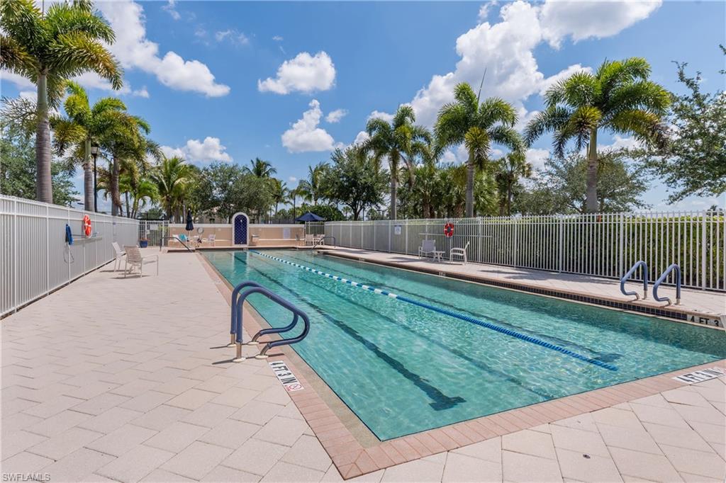 7221 Bellini Way Naples, FL 34114 - Photo 36 of 43 a view of swimming pool with a bench and trees
