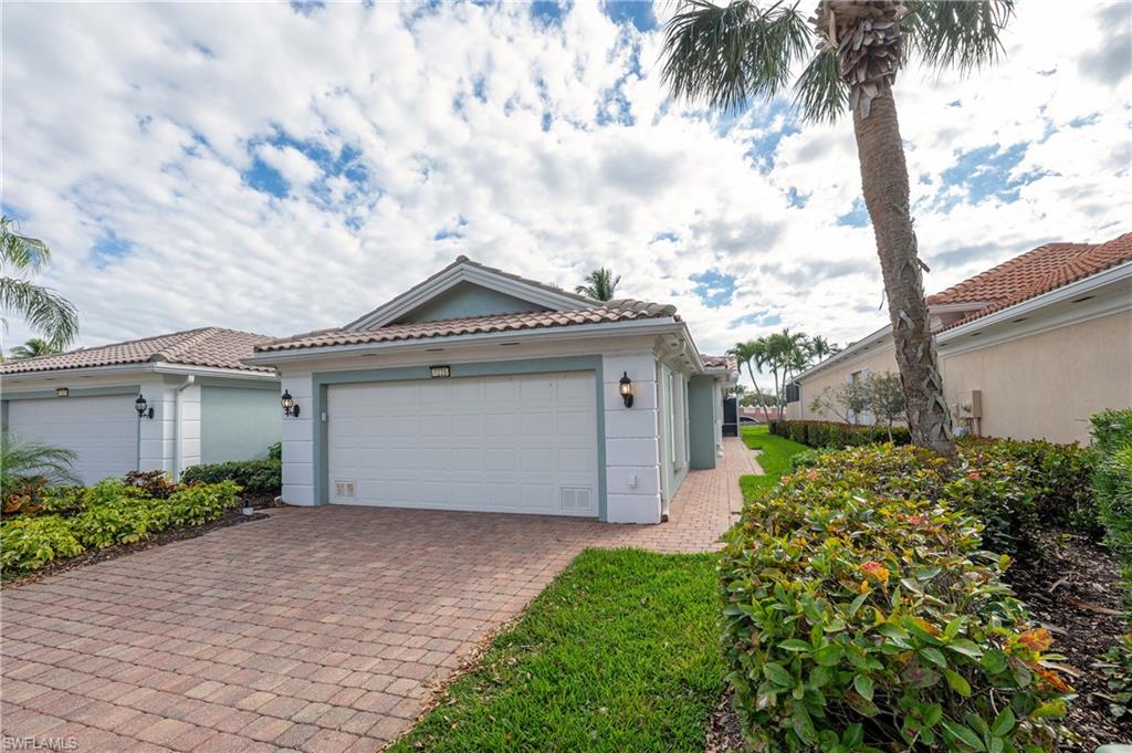 7221 Bellini Way Naples, FL 34114 - Photo 42 of 43 a front view of a house with garden