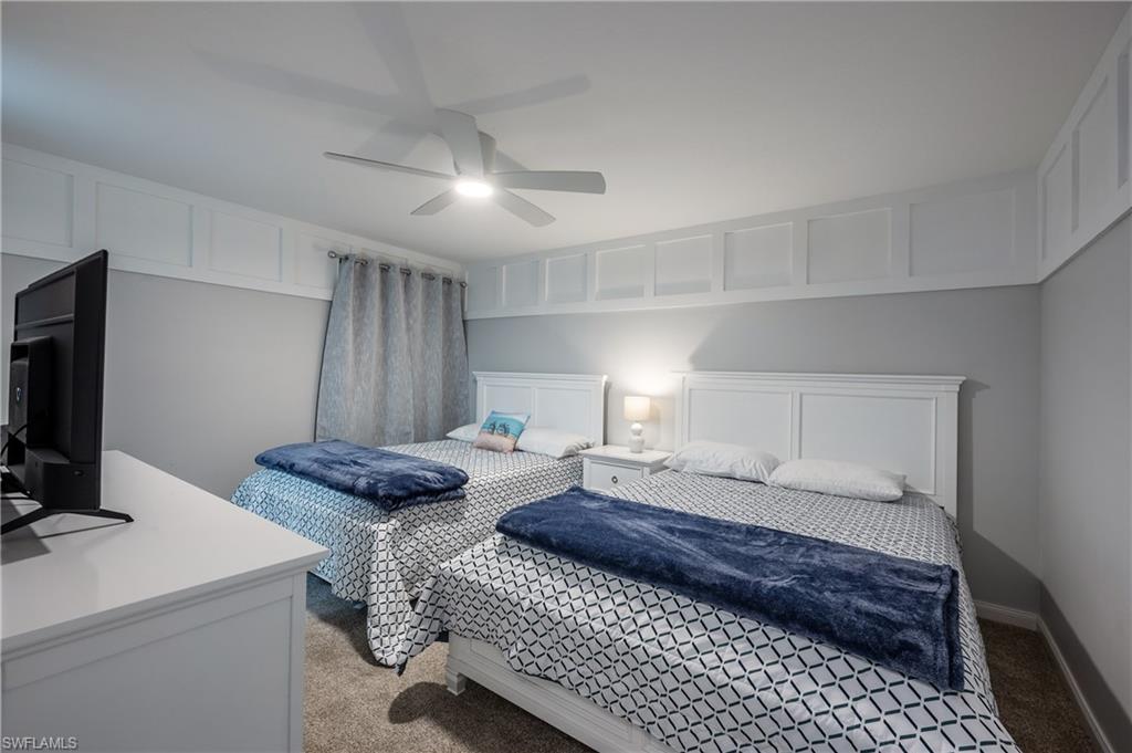 7221 Bellini Way Naples, FL 34114 - Photo 7 of 43 a bedroom with a bed and a flat screen tv