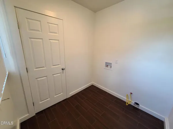 a view of a small space with wooden floor and a window