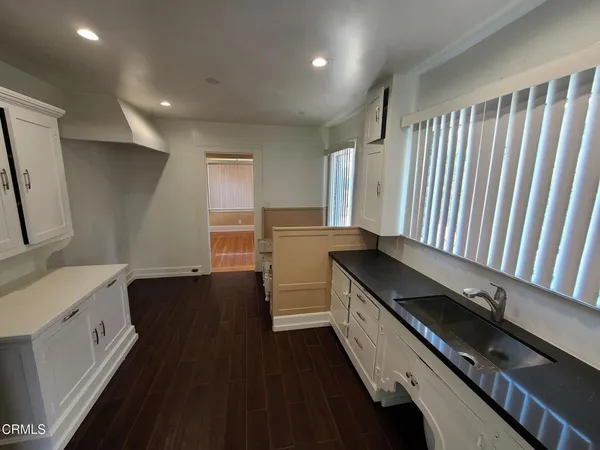 a kitchen with granite countertop a stove and a sink