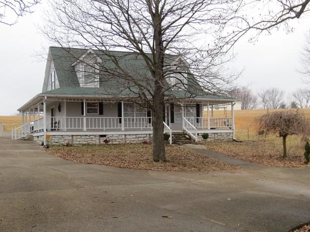 556 Womack Road Bethpage, TN 37022 - Photo 1 of 15 a view of a large white house with large tree and wooden fence