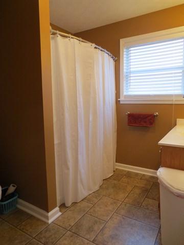 556 Womack Road Bethpage, TN 37022 - Photo 9 of 15 a view of a bathroom with tub and window