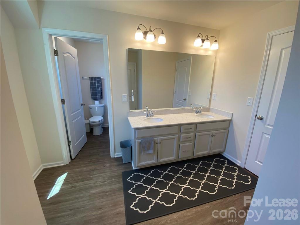 6434 Raffia Road Charlotte, NC 28277 - Photo 13 of 32 a bathroom with a sink and a mirror