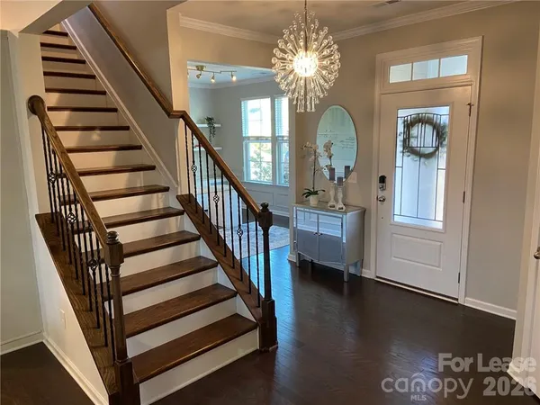 wooden floor view with staircase and living room view