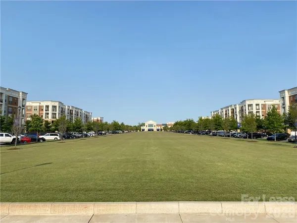 a front view of a residential apartment building with a yard