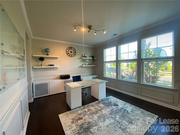 a large white kitchen with a large window