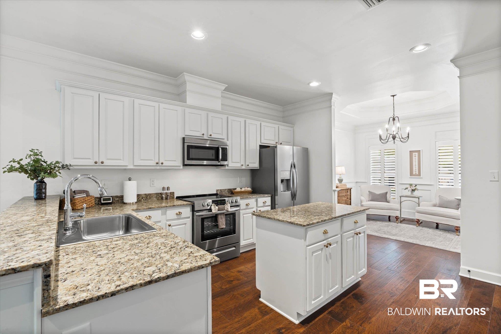 1052 Linlen Avenue Mobile, AL 36609 - Photo 7 of 22 Kitchen featuring light stone counters, stainless steel appliances, white cabinetry, dark wood-style flooring, and ornamental molding
