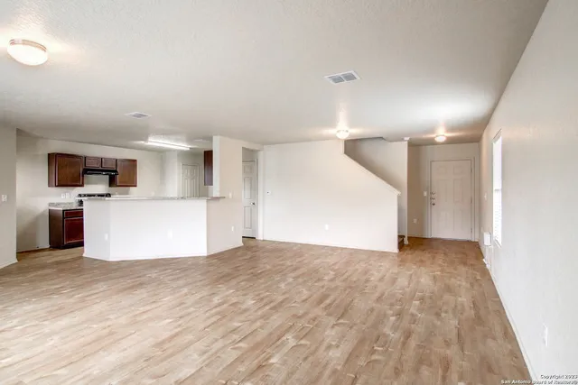 a view of a kitchen with a sink and a refrigerator