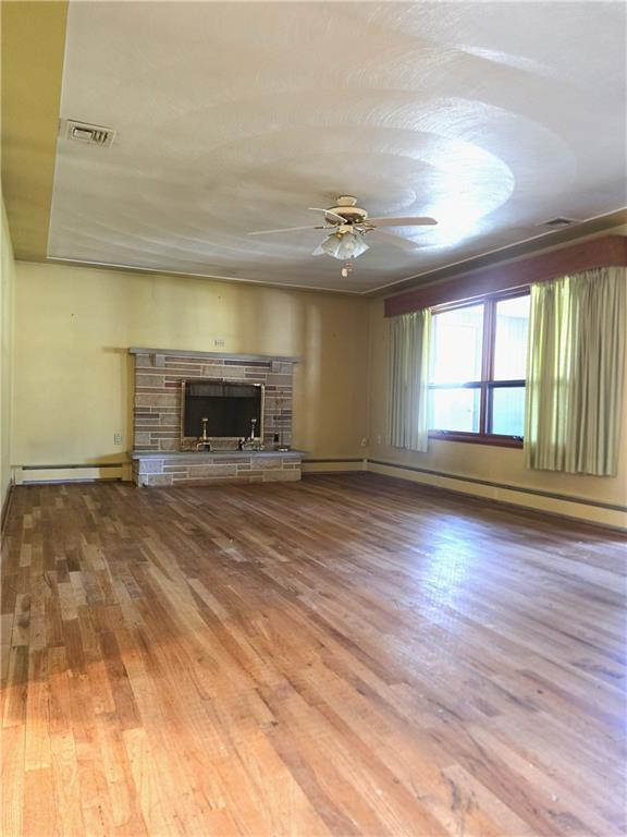 770 Pittsburgh Road Butler, PA 16002 - Photo 12 of 32 wooden floor in an empty room with a fireplace