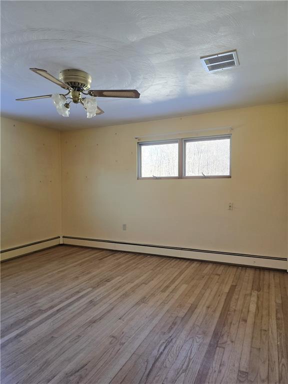770 Pittsburgh Road Butler, PA 16002 - Photo 16 of 32 a view of an empty room with window and wooden floor