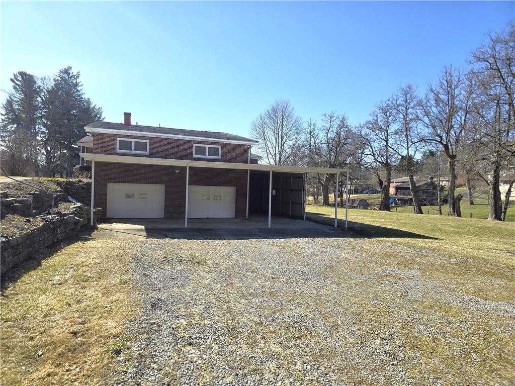 770 Pittsburgh Road Butler, PA 16002 - Photo 30 of 32 a view of a house with a yard and garage