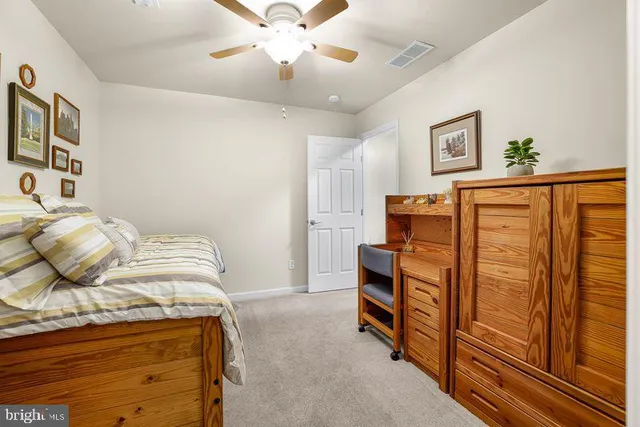a view of a house with a large window and wooden fence