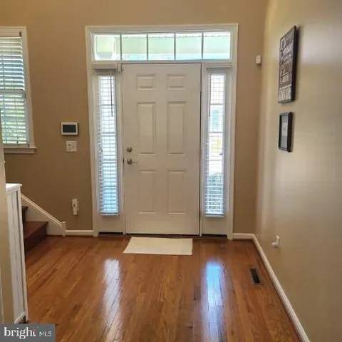 a view of an entryway with workspace and stairs