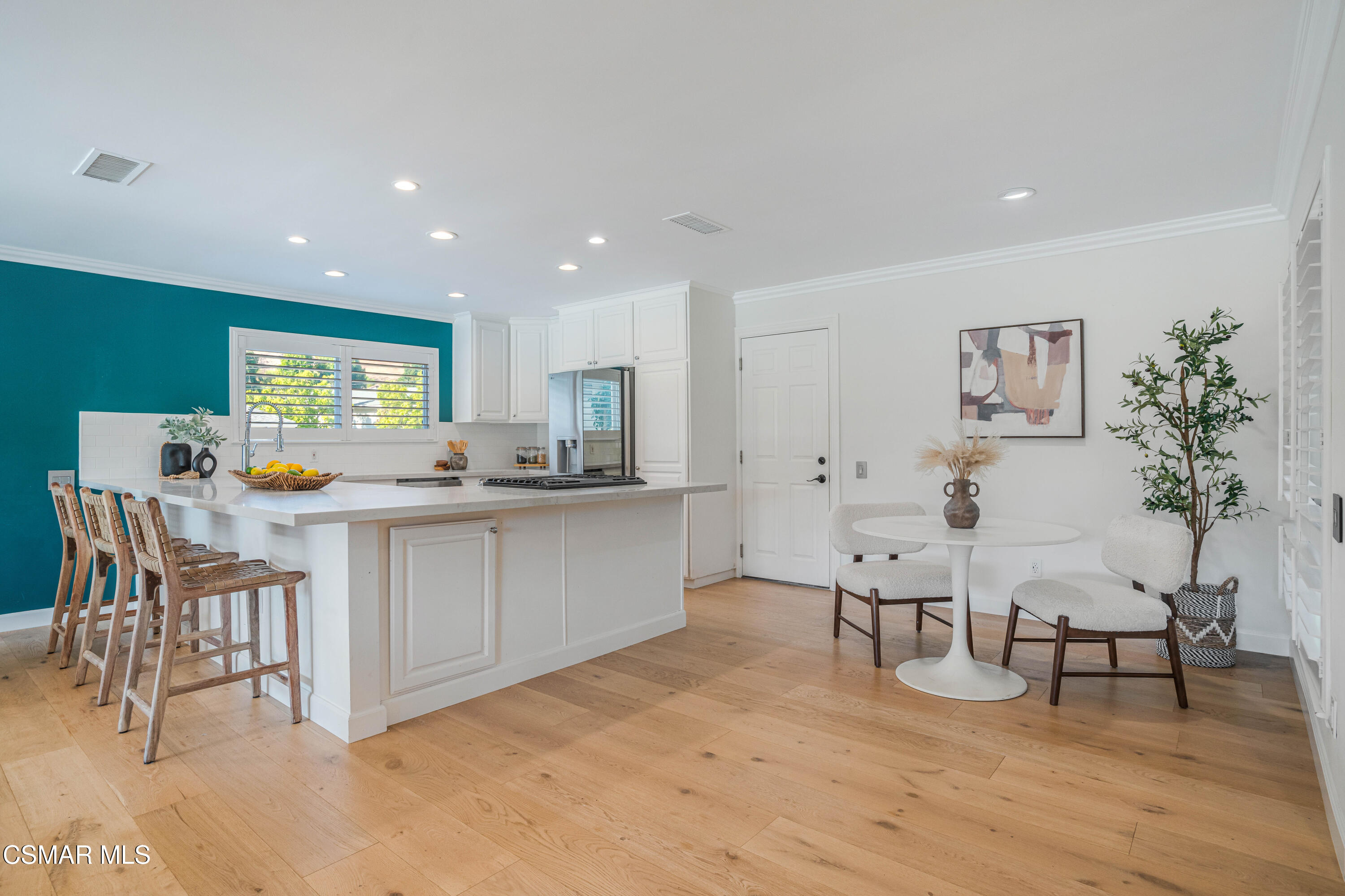 5839 Parkmor Road Calabasas, CA 91302 - Photo 11 of 42 a kitchen with white cabinets and chairs