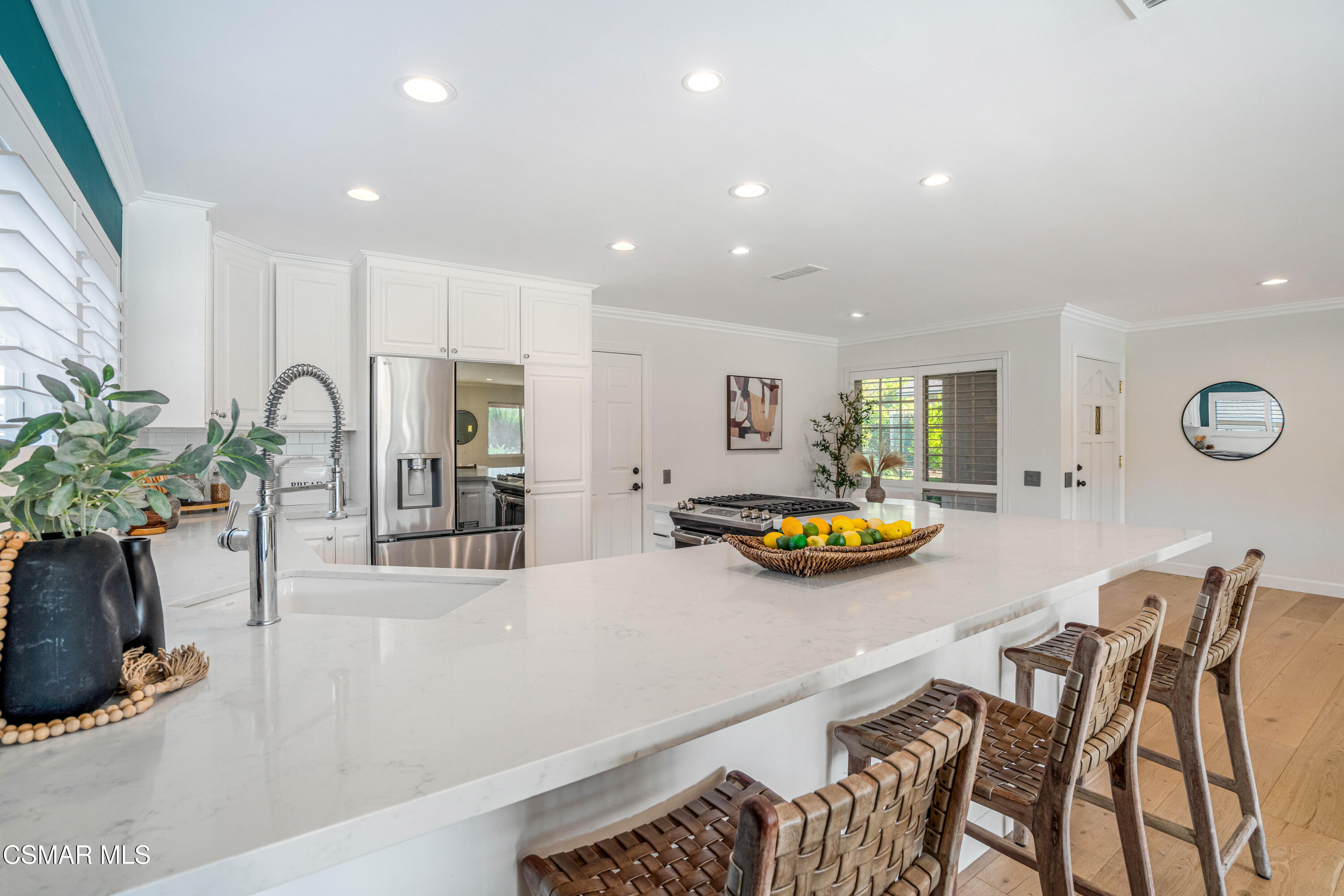 5839 Parkmor Road Calabasas, CA 91302 - Photo 16 of 42 a kitchen with stainless steel appliances a table and chairs in it