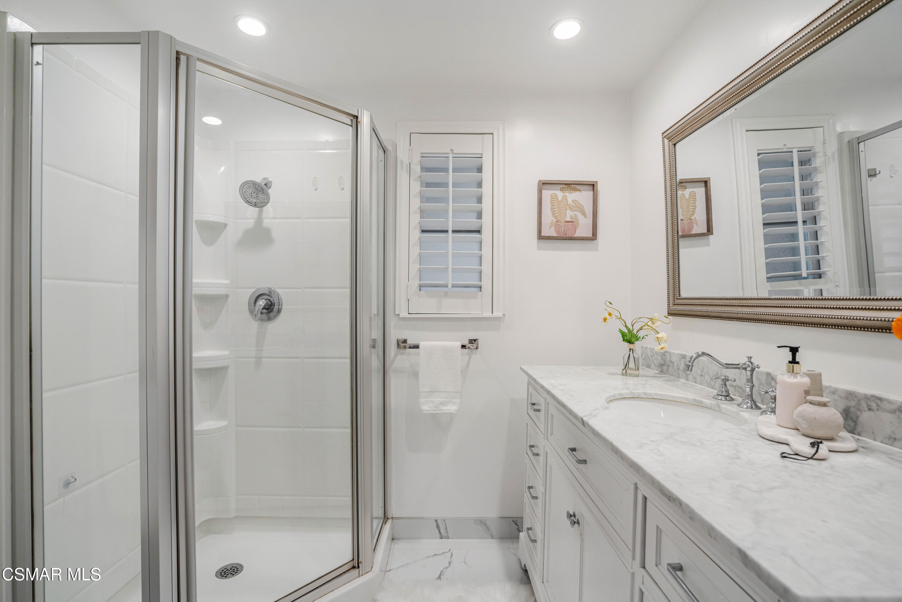 5839 Parkmor Road Calabasas, CA 91302 - Photo 21 of 42 a bathroom with a granite countertop sink a shower and a mirror