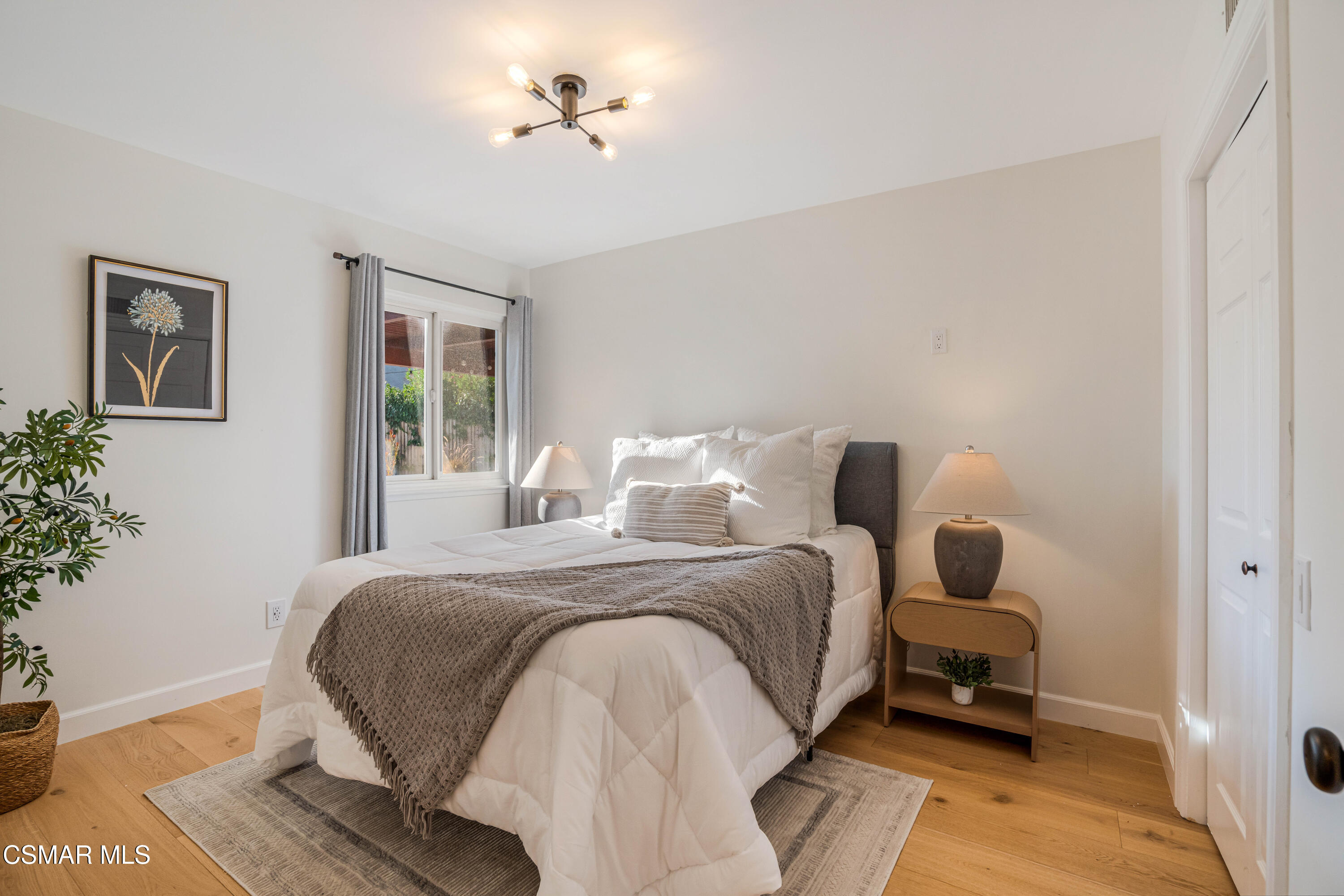 5839 Parkmor Road Calabasas, CA 91302 - Photo 23 of 42 a bedroom with a bed and wooden floor