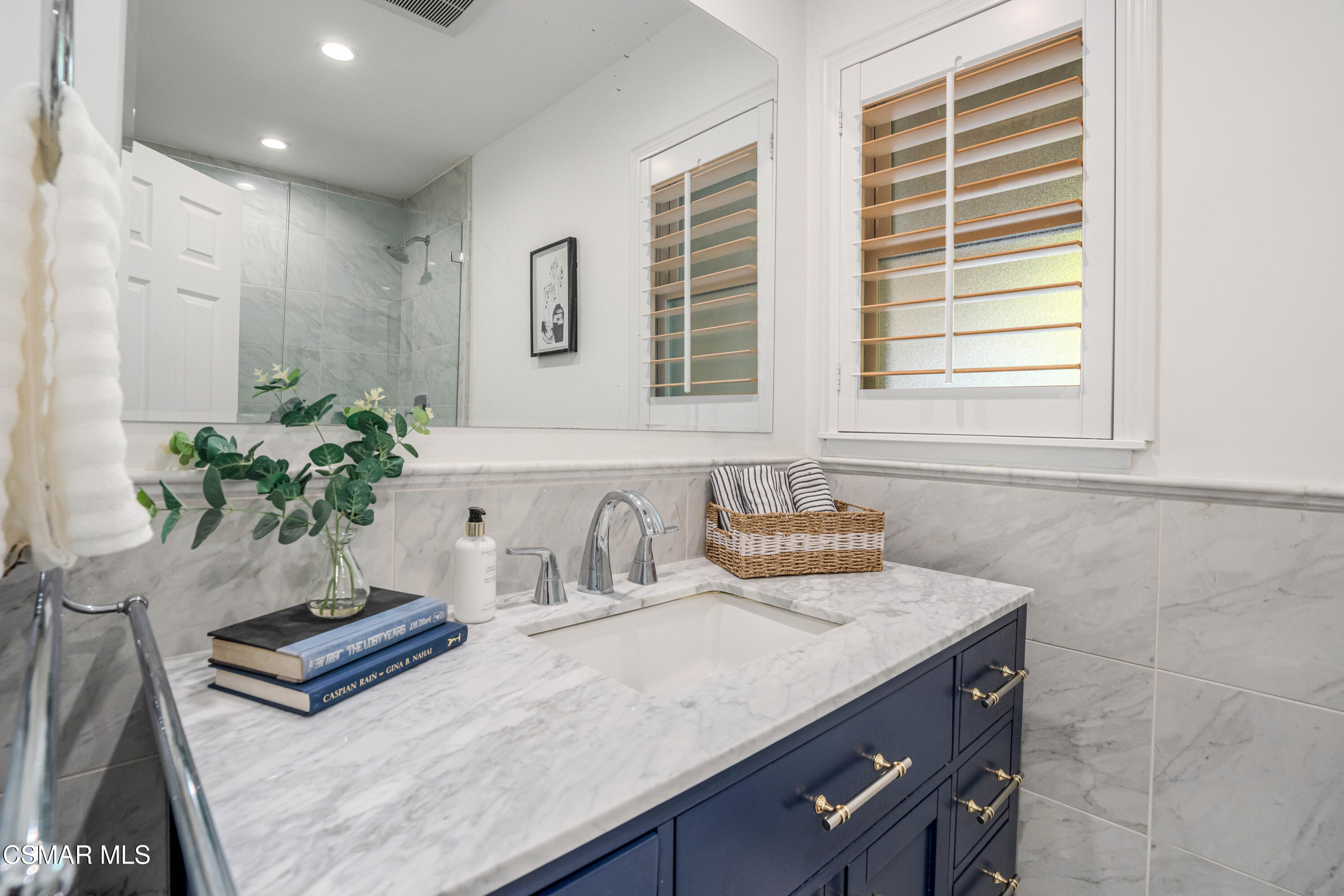 5839 Parkmor Road Calabasas, CA 91302 - Photo 24 of 42 a bathroom with a sink a potted plant and a window