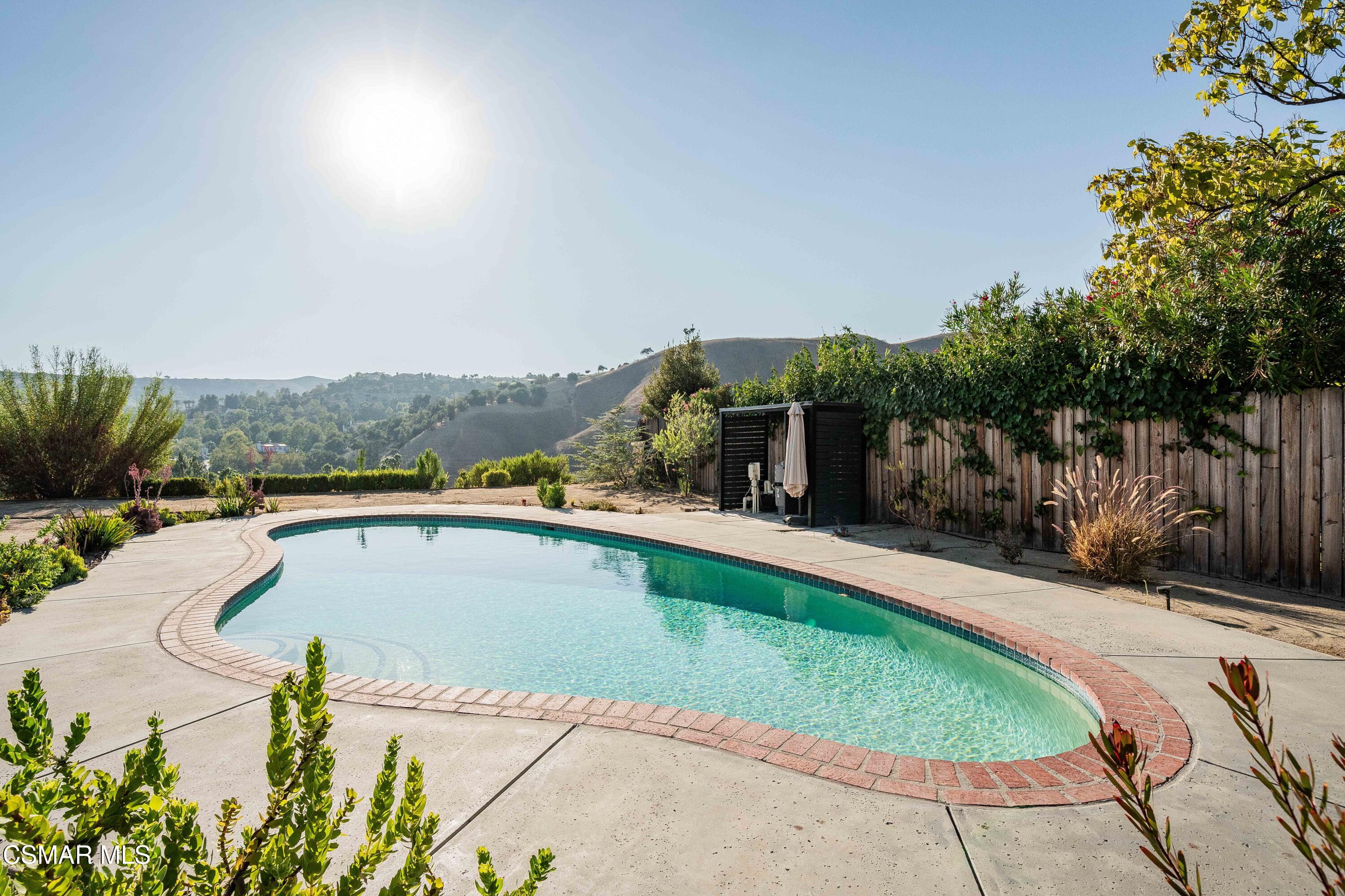 5839 Parkmor Road Calabasas, CA 91302 - Photo 29 of 42 a view of a swimming pool with a patio