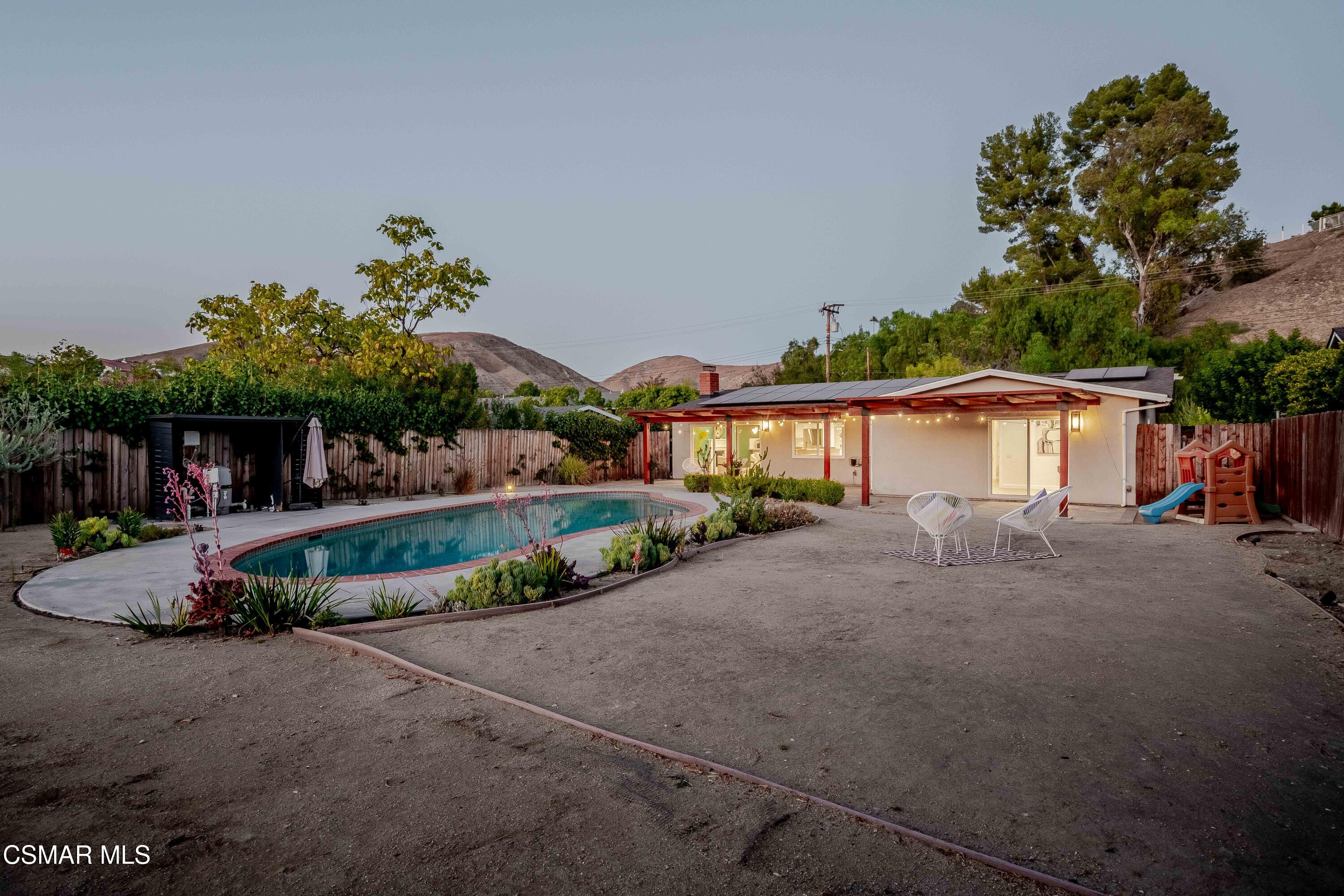 5839 Parkmor Road Calabasas, CA 91302 - Photo 31 of 42 a front view of a house with a yard and a garage