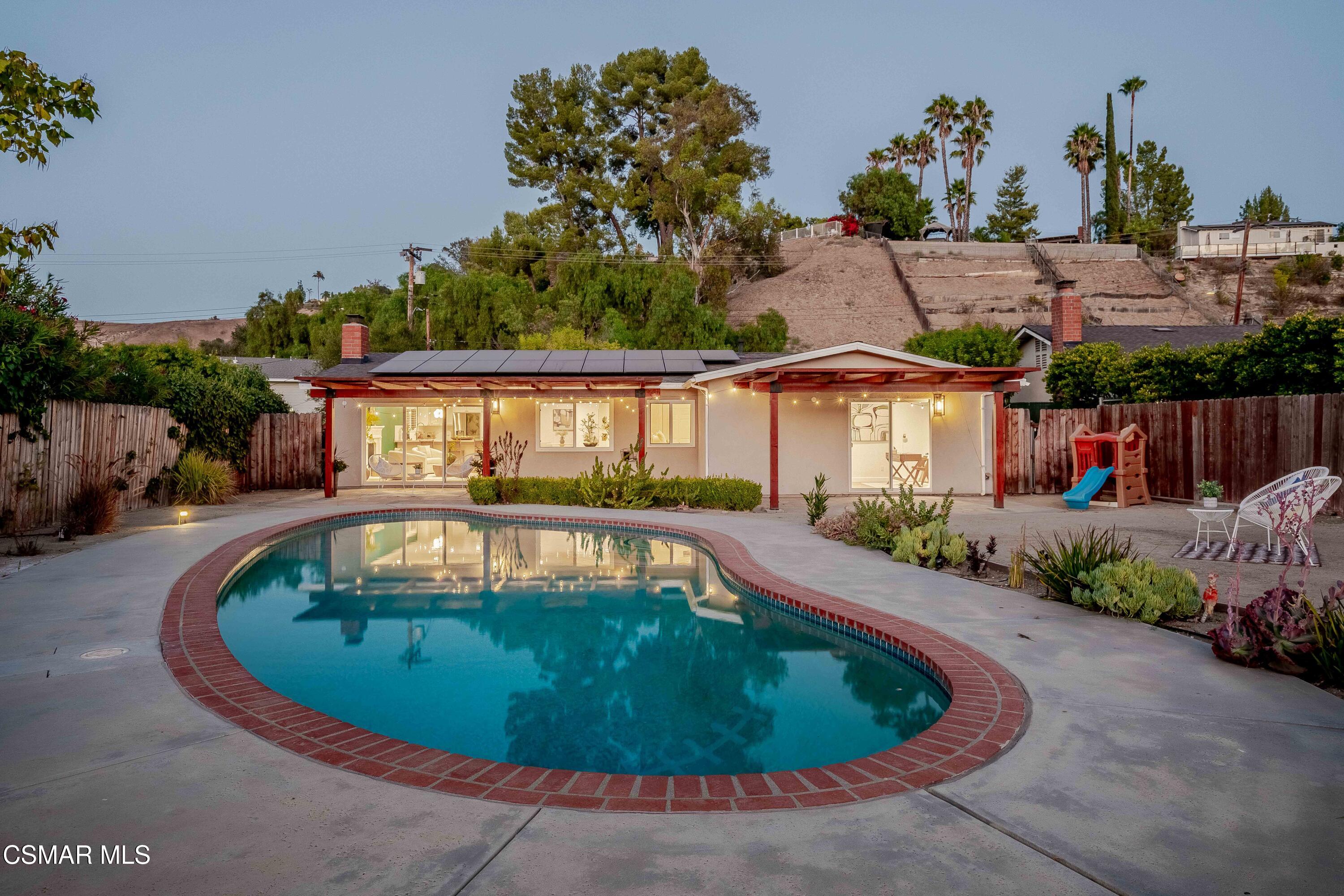 5839 Parkmor Road Calabasas, CA 91302 - Photo 32 of 42 a view of a swimming pool with an outdoor seating