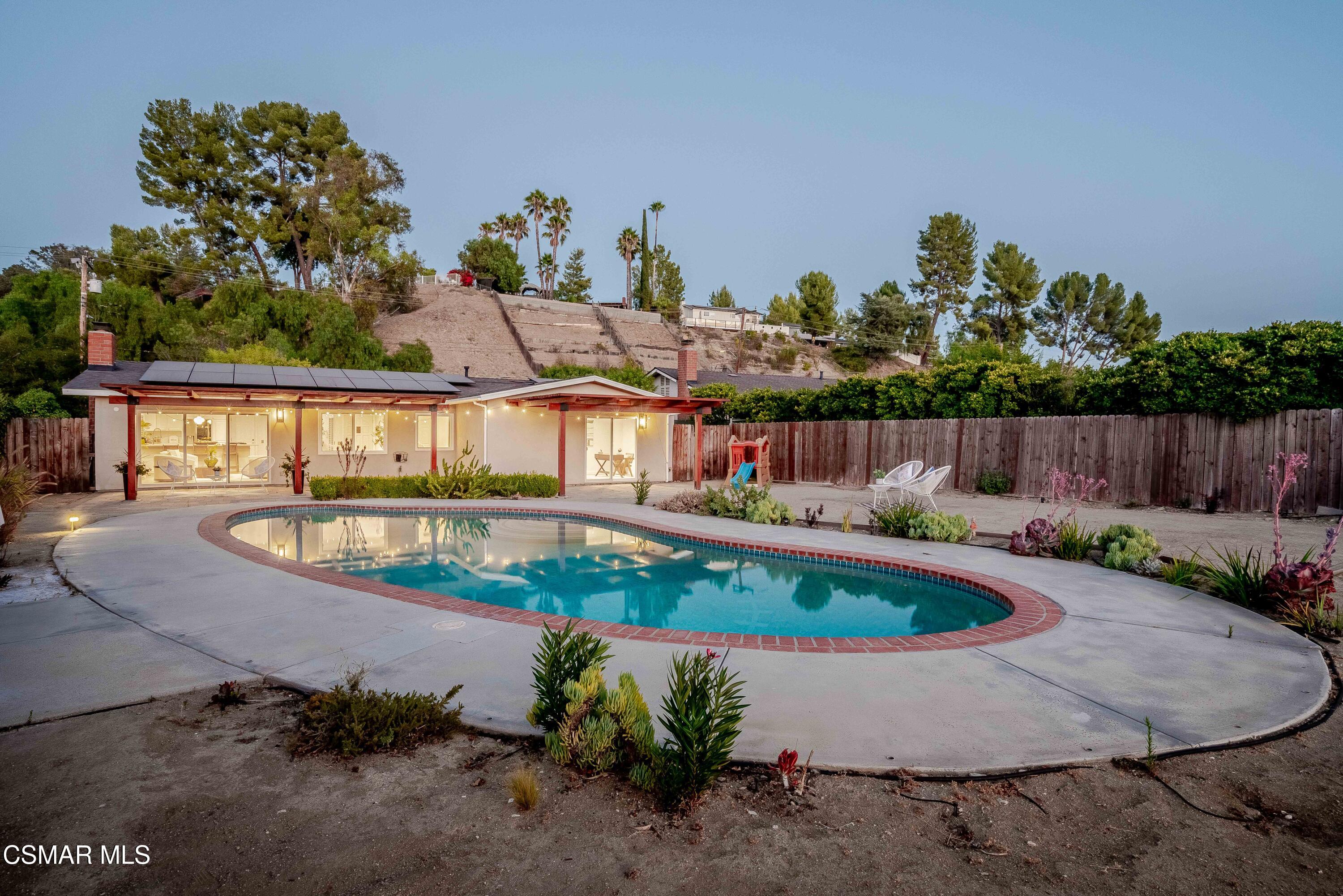 5839 Parkmor Road Calabasas, CA 91302 - Photo 33 of 42 a view of a swimming pool with a yard