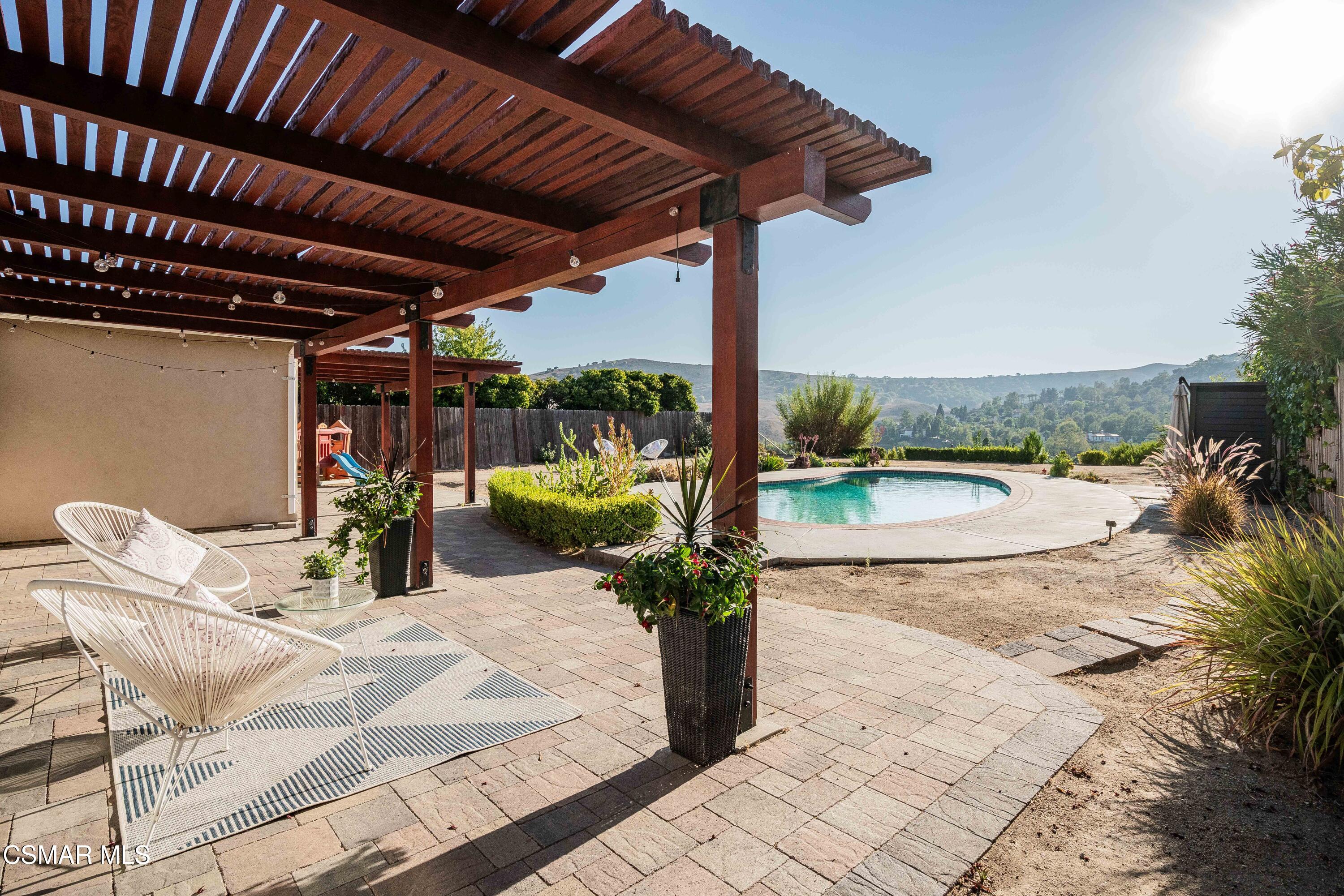 5839 Parkmor Road Calabasas, CA 91302 - Photo 36 of 42 a view of a porch with furniture and a yard