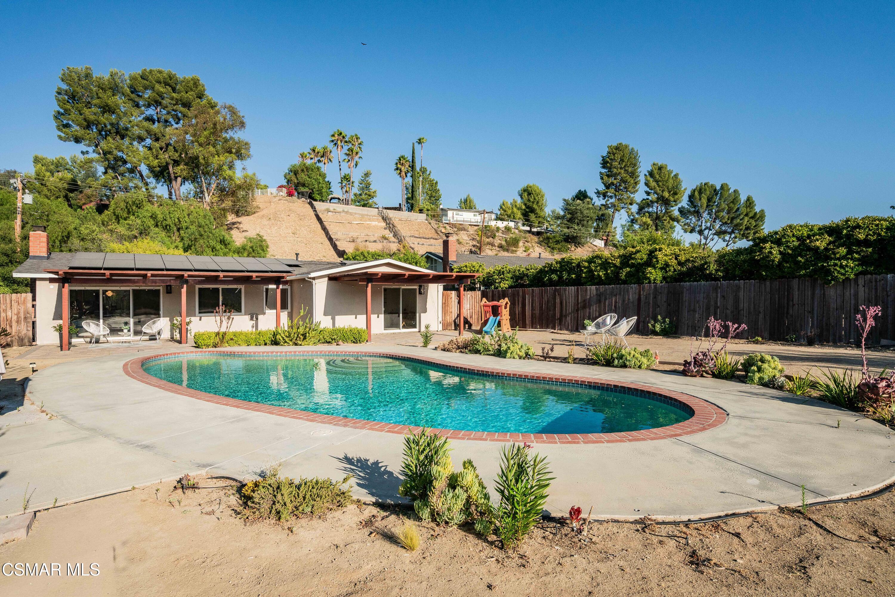 5839 Parkmor Road Calabasas, CA 91302 - Photo 40 of 42 a front view of a house with swimming pool having outdoor seating