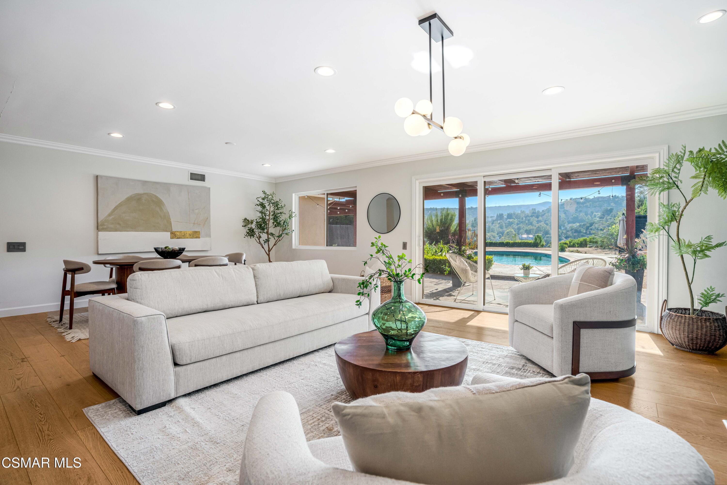 5839 Parkmor Road Calabasas, CA 91302 - Photo 9 of 42 a living room with furniture potted plant and a large window