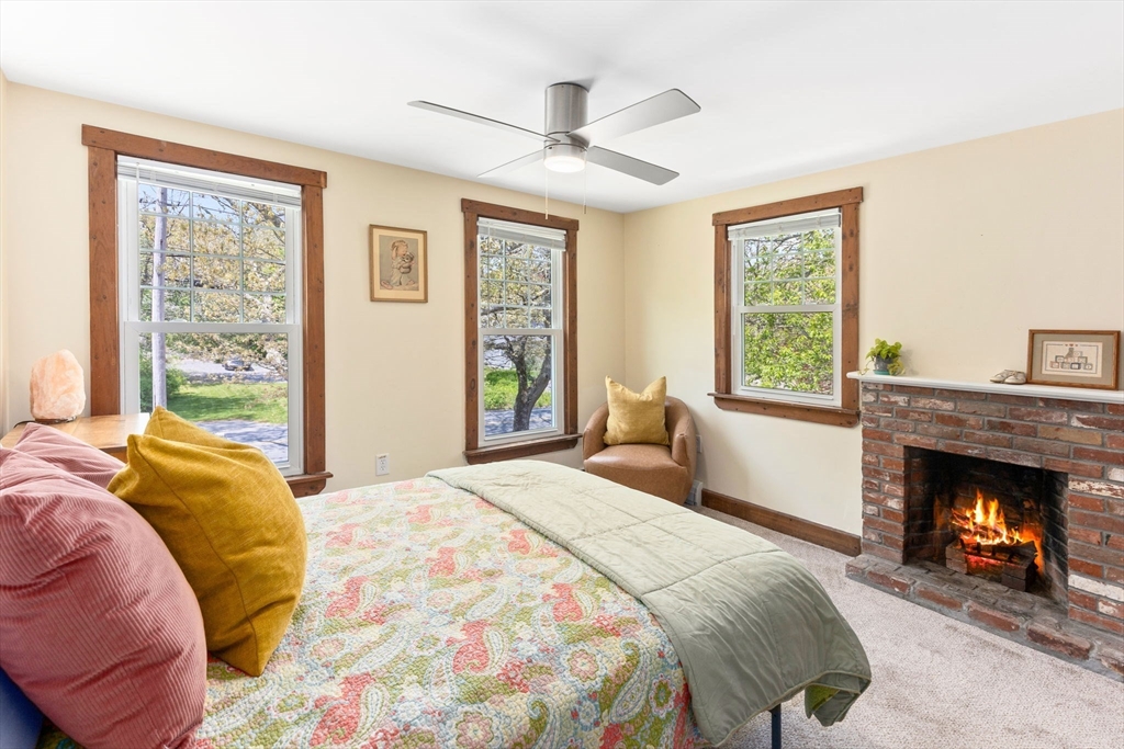 1020 Old Falmouth Road Barnstable, MA 02632 - Photo 32 of 42 a bedroom with a bed and a fireplace