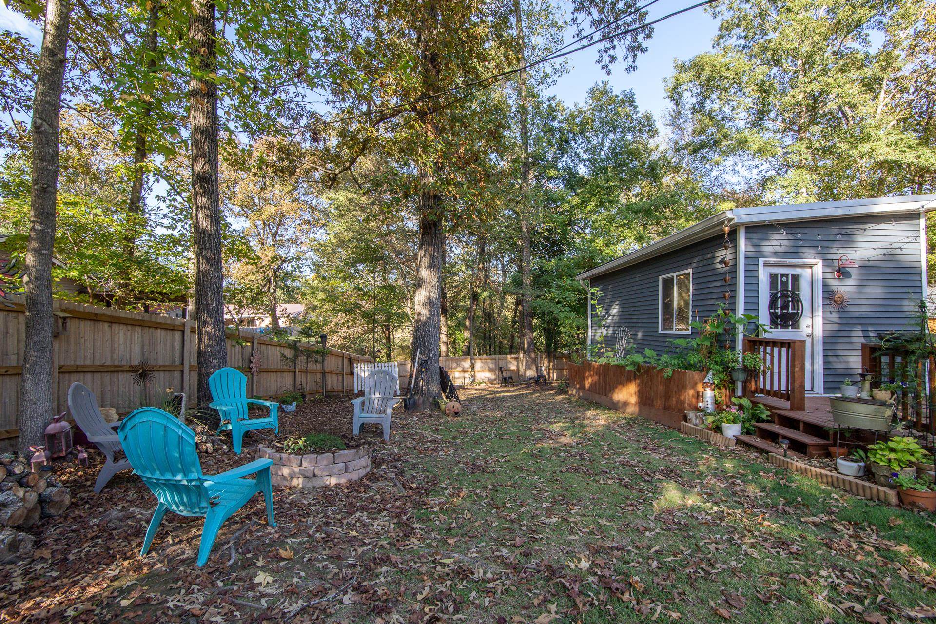225 Lew Wallace Road Crump, TN 38327 - Photo 28 of 40 a view of a backyard with chairs and a fire pit