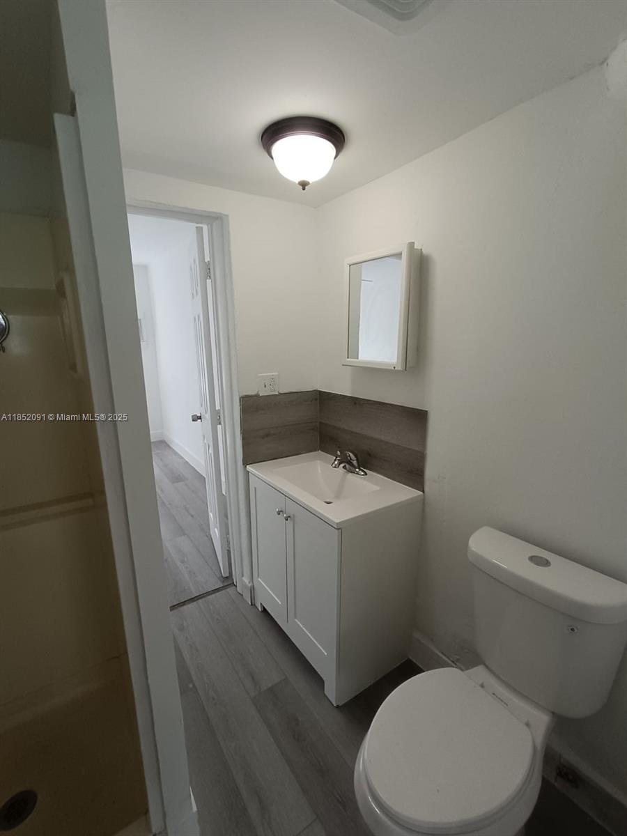 1857 Southwest 4th Street, Unit 3 Miami, FL 33135 - Photo 6 of 10 a white toilet sitting next to a bathroom sink