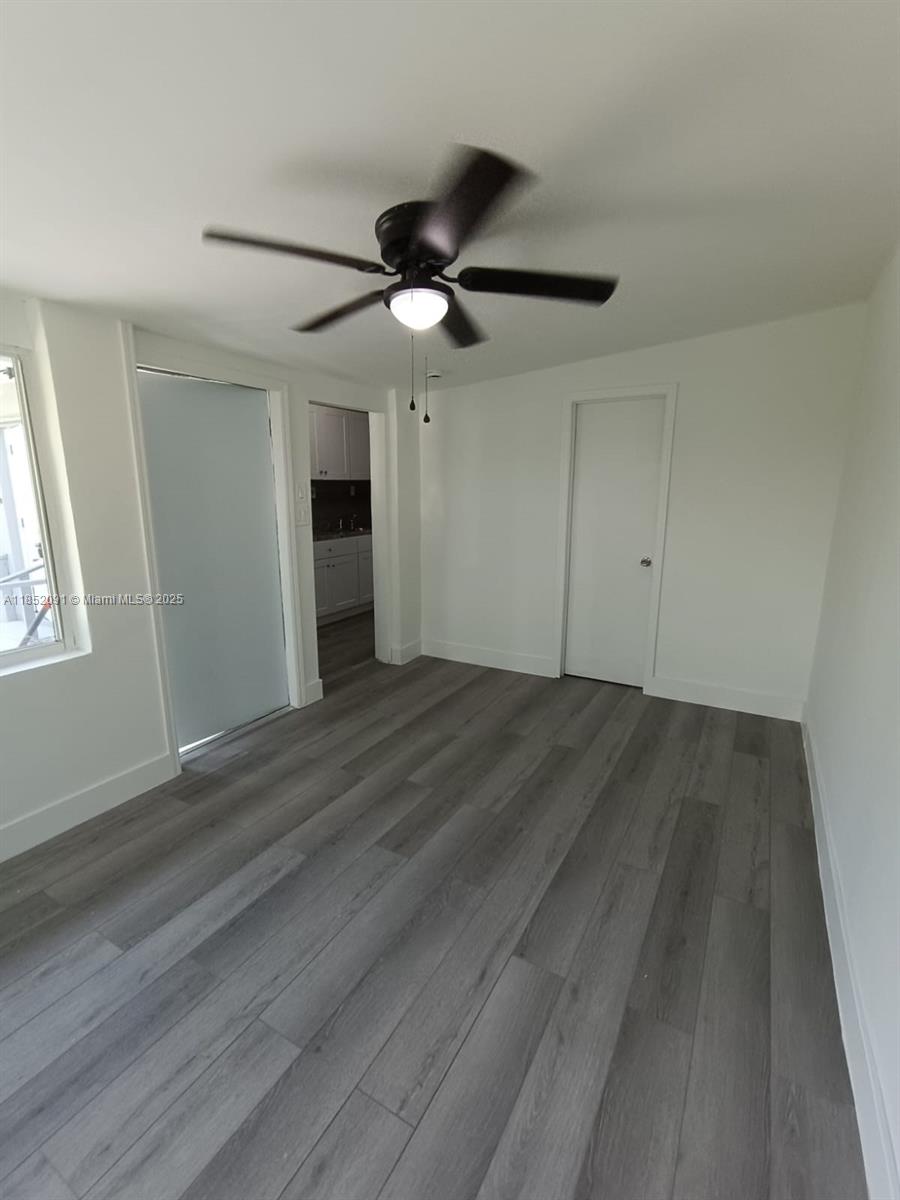 1857 Southwest 4th Street, Unit 3 Miami, FL 33135 - Photo 9 of 10 a view of empty room with wooden floor and fan