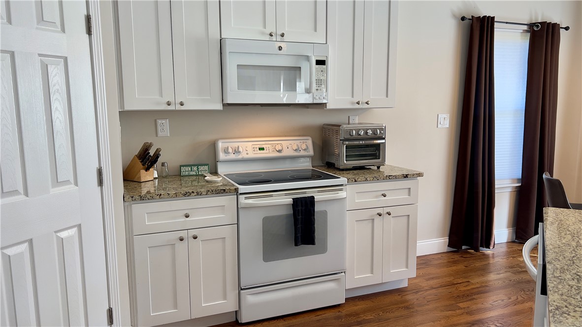 160 Hudgins Lake Road Townville, SC 29689 - Photo 36 of 41 A open kitchen with white cabinetry and granite countertops offers modern efficiency.