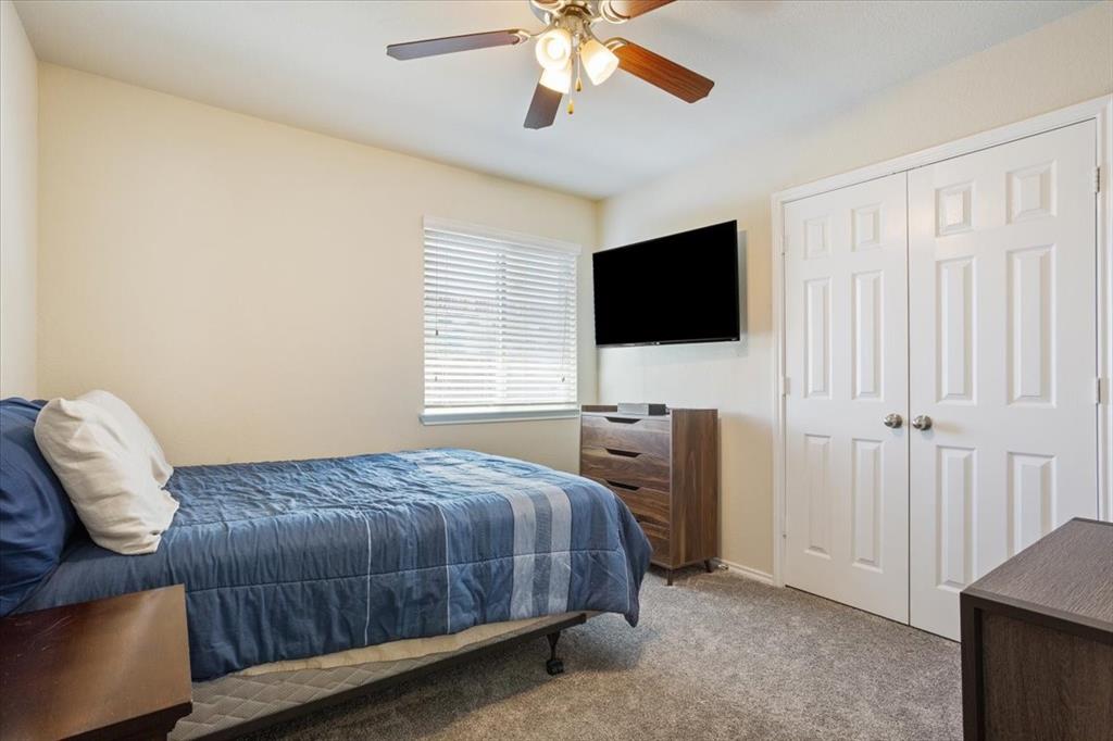 5308 Tama Drive Waco, TX 76708 - Photo 21 of 29 a bedroom with a bed and a flat screen tv