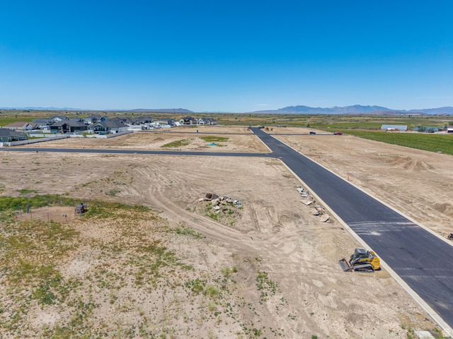 3150 South 5250 West, Unit 210 Hooper, UT 84315 - Photo 5 of 11 Expansive vacant land parcels featuring newly paved roads and clear skies