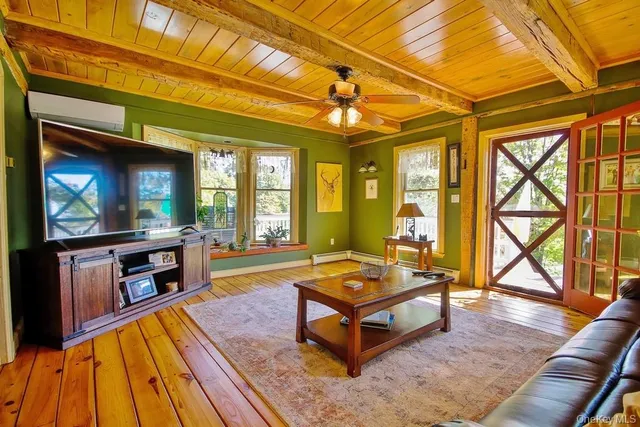 a living room with a flat screen tv and a fireplace