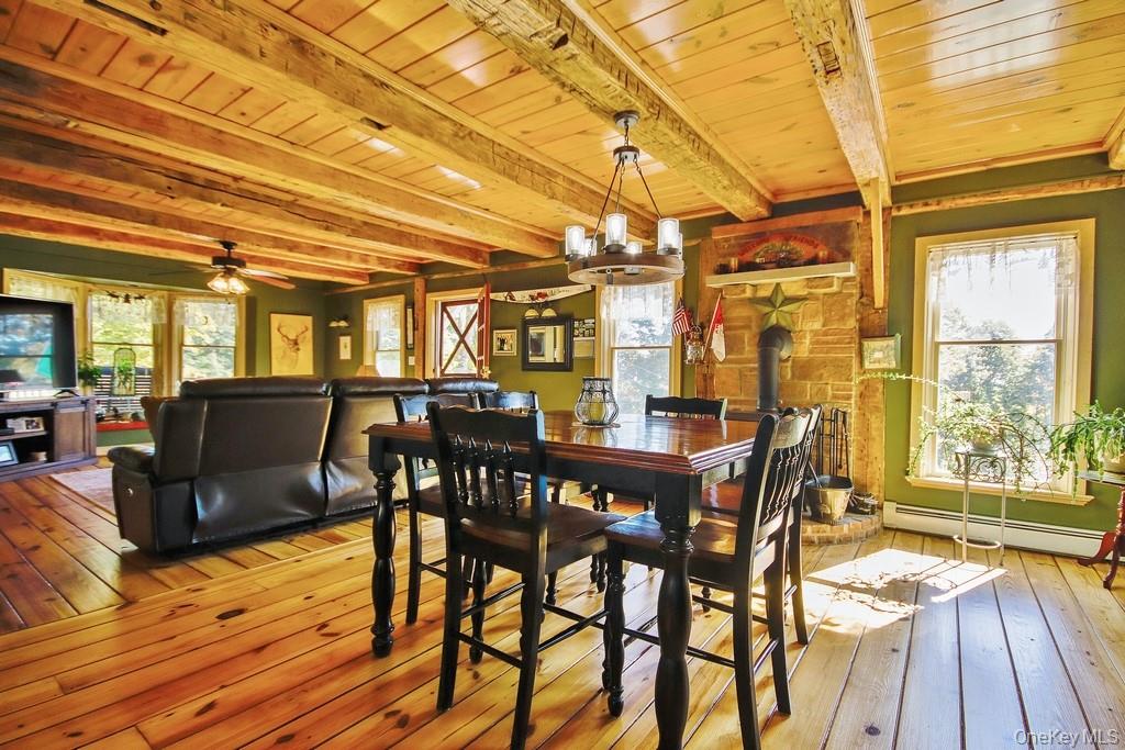575 Roosa Gap Road Bloomingburg, NY 12721 - Photo 18 of 50 a view of a dining room with furniture and wooden floor